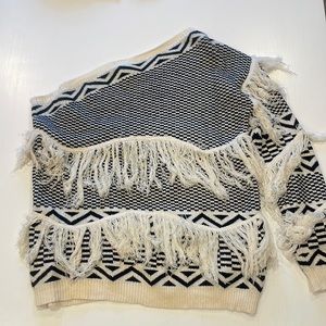 Fun one shoulder sweater.Size medium. Black and white pattern with fringe detail